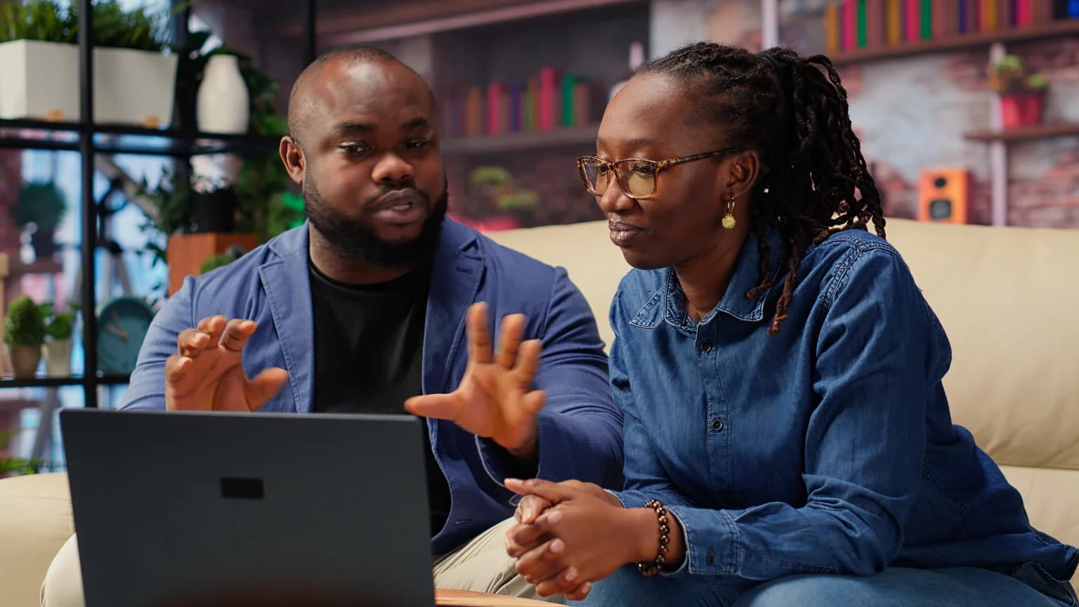 A one-to-one mentoring session at a table with a laptop